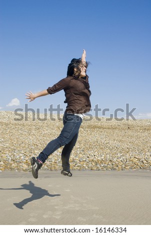 young girl jump high in the beach