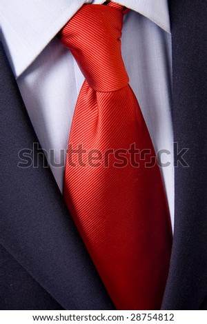 red necktie, black suit and blue collar detail