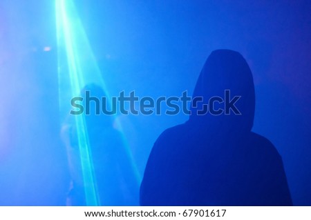 Silhouette of hooded man and enlightened woman party dancing