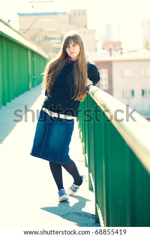 fashion vintage full length portrait of attractive young woman posing over the blurred city view