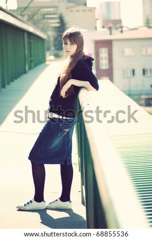 fashion vintage full length portrait of beautiful young woman posing over the blurred city view