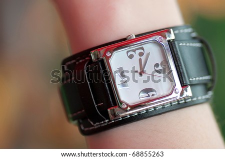 Watch on the women\'s hand with blurred background
