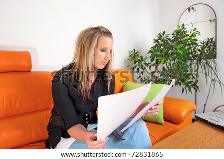 Portrait of a thoughtful young woman reading papers