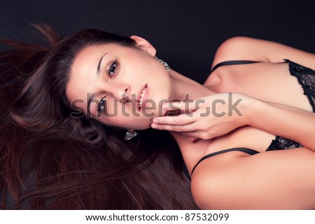 Beautiful young woman lying on the floor