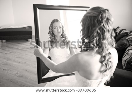 Bride looking into mirror