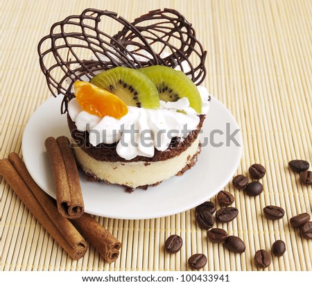 Cake with fruits, coffee beans and cinnamon sticks