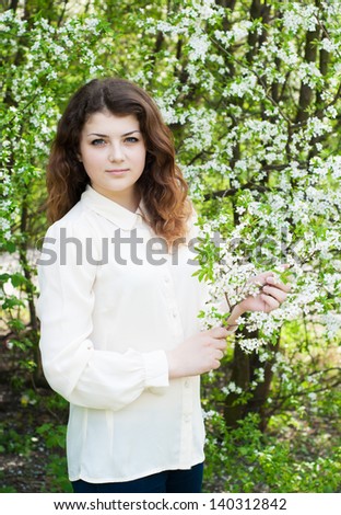 portrait of young brunette in the spring garden