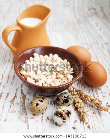 Muesli, wheat. milk  and eggs on a wooden background