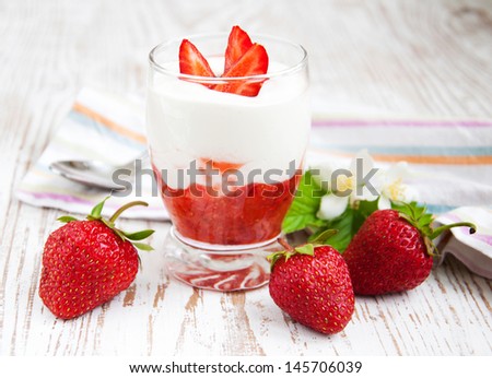 Glass of strawberry yogurt, with fresh strawberries