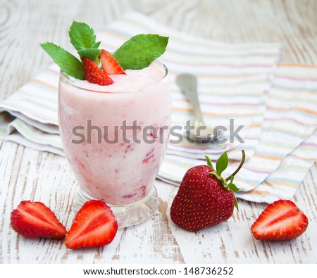 Glass of strawberry yogurt, with fresh strawberries