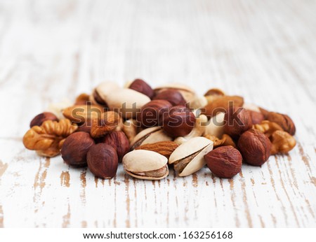 Mixed nuts on a old wooden background