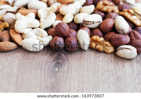 Mixed nuts on a old wooden background - Nuts  frame