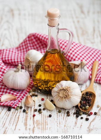 Olive Oil, Garlic and Pepper on a wooden background