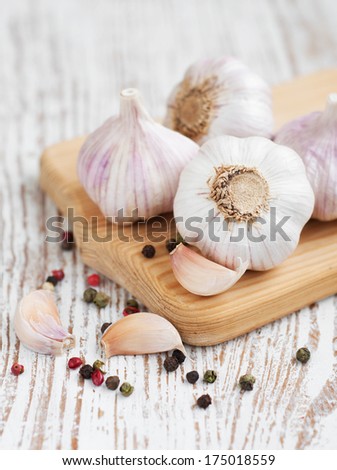 Garlic with peppercorns on a wooden background