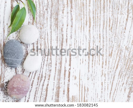 Spa background  with spa stones and green leaves