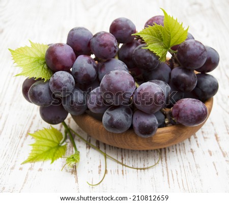 fresh red grapes served in wood plate