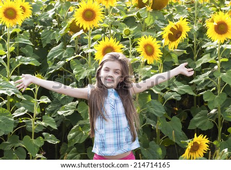 Beautiful child  with sunflower in summer field