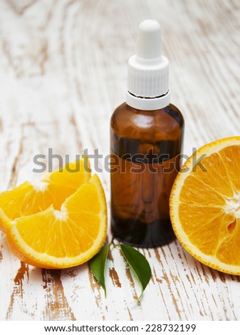 orange essential oil with fresh fruits - beauty treatment