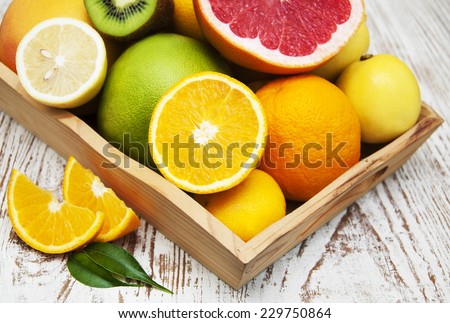 Variation of Citrus Fruits with leaves on the wooden box