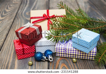 christmas trees with heap of gift boxes on a wooden background