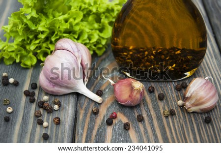 Oil and garlic on a wooden background