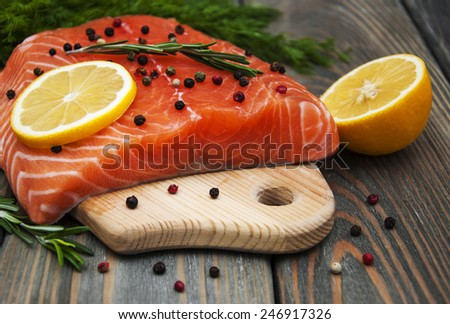 salmon fish with fresh herbs,  lemon and pepper