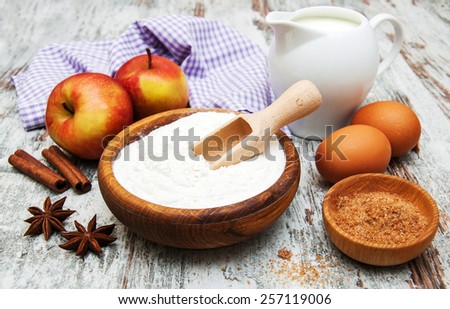 ingredients for apple pie - red apple, butter, flour, brown sugar, nuts and spices