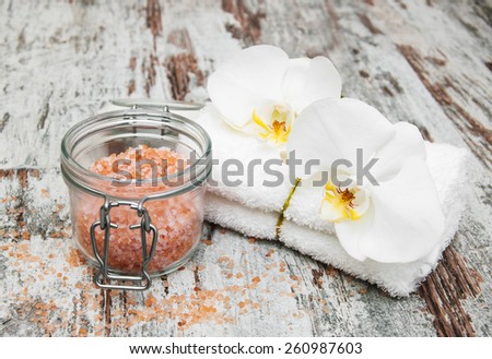 spa still life - a flowers  and towels  on a wooden background
