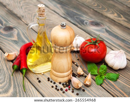 olive oil,  basil, tomato and garlic on a wooden background
