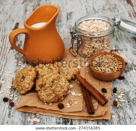 Oatmeal cookies with milk on a old wooden table