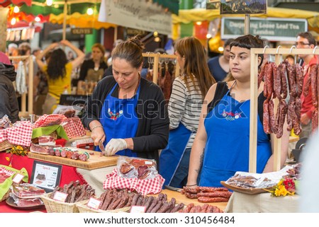 LONDON - JUN 12, 2015: Homemade smoked sausage at a farmers\' market. Borough market, London, UK.