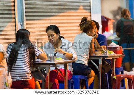 PHUKET, THAILAND - APRIL 26, 2015: Some customers are sitting at the restaurant tables.