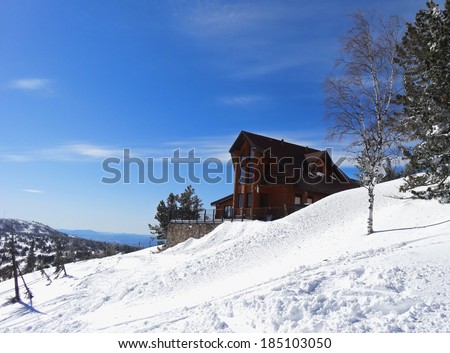 The house in mountains in the clear winter day