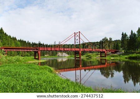 The automobile bridge through the Chusovaya river in summer day. Ural. Russia.