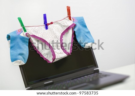 Women\'s cowards and socks are  drying on the monitor of a laptop. Humor.