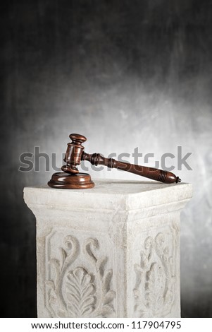 High quality mahogany gavel with sound block on a plaster column.