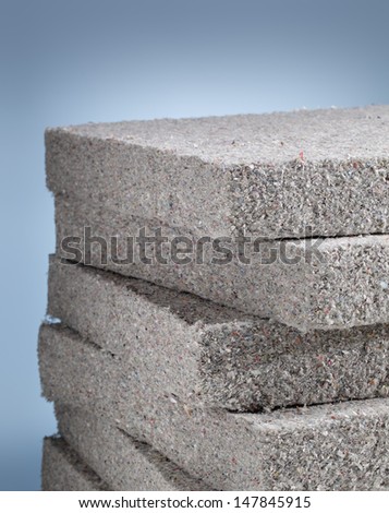 Stack of cellulose insulation batt panels, made of recycled newspapers, used as building thermal insulation.