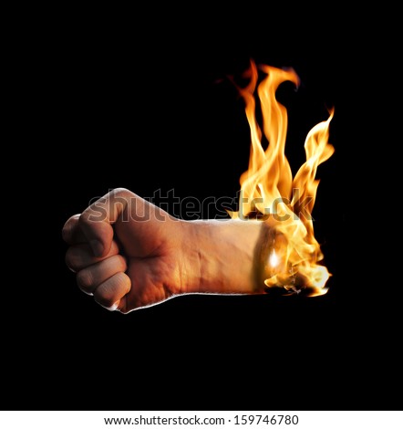 A burning fisted hand on black background.