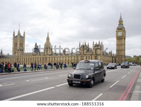 LONDON, UK - APRIL 18, 2014: Black taxi cab in front of the Palace of Westminster.