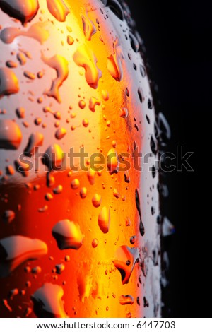 Brown beer bottle with some droplets. Short depth-of-field