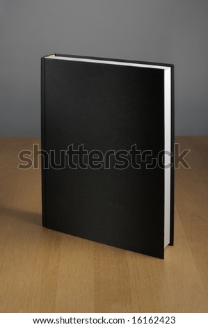 A Black book on a table