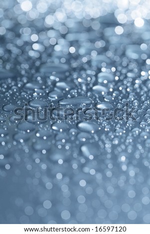 Water beads on a metallic blue car.