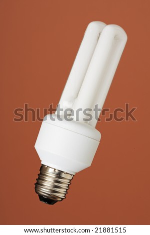 Energy saving compact fluorescent bulb on brown background