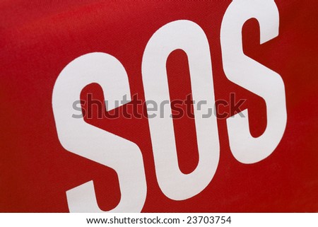 SOS - save our souls - text on red fabric emergency kit