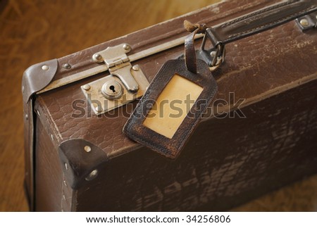An old suitcase with a luggage tag.