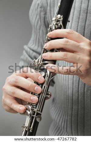 Man playing wood wind instrument clarinet