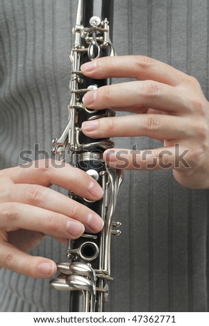 Man playing Clarinet, a woodwind instrument.