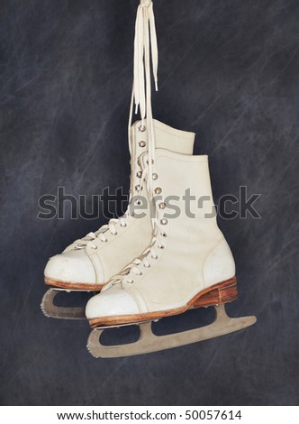 Old womens figure skates hanging from their laces