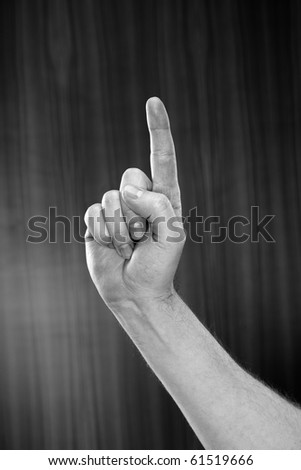 Black and white image of man pointing with his index finger