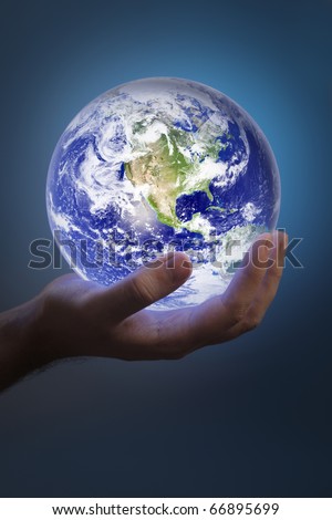 Man holding a glowing earth in his hand. Earth image provided by NASA.